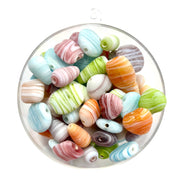 An assorted mix of matt glass beads with a swirl pattern, ranging in size from approximately 12mm - 20mm.
Each pack contains a random mix of colours, shapes and sizes. Made in India.