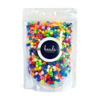 Packaged colorful pony beads with 'Beads by Craftworkz' label on a white background