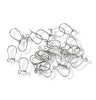 Collection of metal earring hooks on a white background