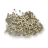 These nickel coloured beading crimps measure approximately 2mm. They are soft metal beads used instead of tying knots to secure clasps and other beads onto un-knottable stringing material such as beading wire. Also available in silver or gold coloured finish.