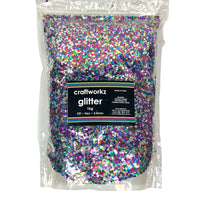 A clear plastic bag filled with multicolored chunky glitter, labelled 'craftworkz glitter 1kg'.