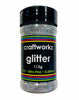 A shaker jar containing ultra fine silver holographic glitter, with label indicating the brand, weight, and characteristics of the glitter.